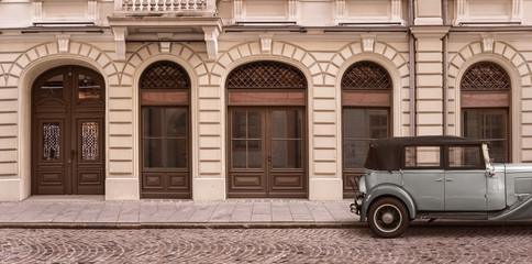 Old empty street background and a retro car with copy space 