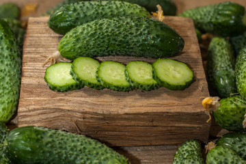 Sliced round slices cucumber on a wooden table. Organic food. Agricultural retailer. Farm food