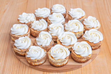 small rounded cakes with pumpkins and white meringue