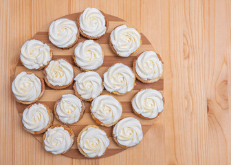 small rounded cakes with pumpkins and white meringue