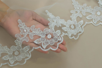 Texture lace fabric. lace on white background studio. thin fabric made of yarn or thread. a background image of ivory-colored lace cloth. White lace on beige background.