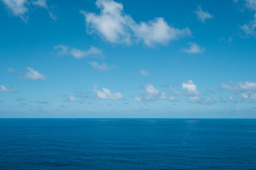 Naklejka na ściany i meble blue sky with clouds over water - ocean horizon , sea background -