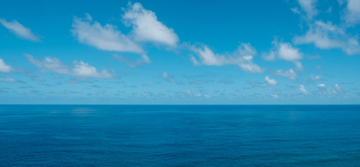 Fototapeta na wymiar blue sky with clouds over water - ocean horizon , sea background -