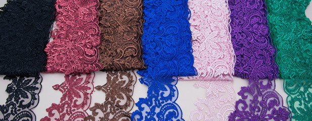 Texture lace fabric. lace on white background studio. thin fabric made of yarn or thread. a background image of ivory-colored lace cloth. Red, green, brown, blue, pink, violet, black lace 