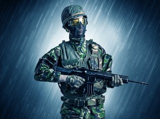 Armed soldier standing in rainy weather