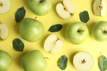 Flat lay composition of fresh ripe green apples on yellow background