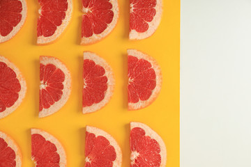 Fototapeta na wymiar Flat lay composition with slices of juicy grapefruit on color background