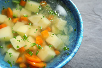 Bowl of fresh homemade vegetable soup on table, closeup