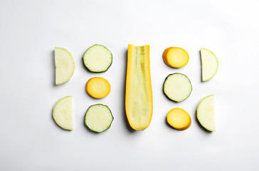 Fresh ripe cut zucchinis on white background, top view