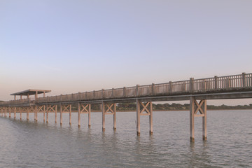 Fototapeta na wymiar Wooden walkway over sea in the marsh