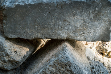 Greek text carved on ancient stones of Phaselis ruins, antient greek city on Antalia coast, Turkey