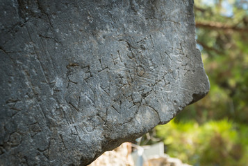 Greek text carved on ancient stones of Phaselis ruins, antient greek city on Antalia coast, Turkey