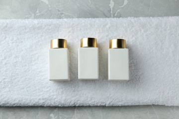 Composition with cosmetic products on grey stone table, flat lay. Spa therapy