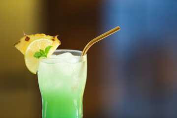 Fresh alcoholic cocktail with pineapple and lemon on blurred background, closeup. Space for text