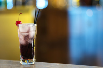 Fresh alcoholic cocktail with cherry on bar counter, space for text