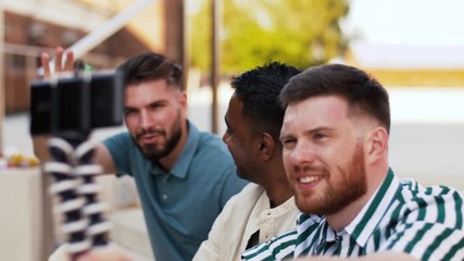 leisure, technology and people concept - happy male friends taking selfie by smartphone and drinking beer at rooftop party in summer