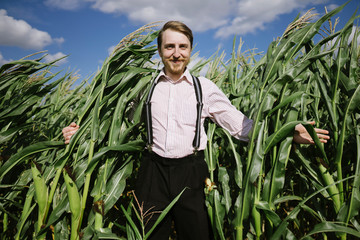 happy farmer guy standing in corn