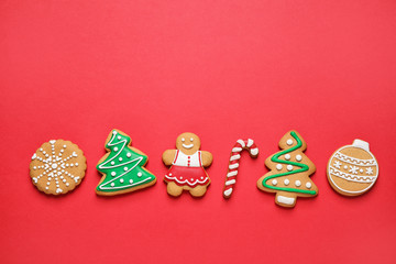 Flat lay composition with tasty homemade Christmas cookies on red background, space for text