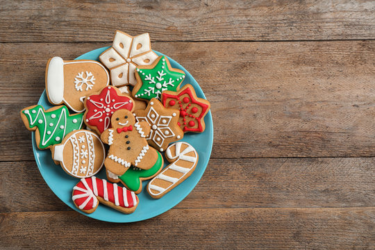 Tasty homemade Christmas cookies on wooden table, top view. Space for text