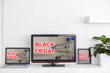 Credit cards in shopping cart and laptop, Black Friday Sale