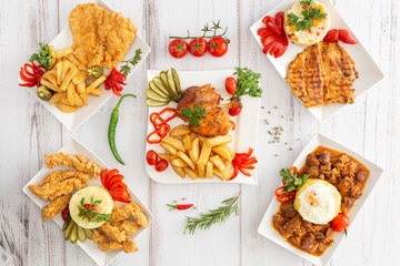 Collage of dishes on white wood background