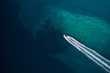 Aerial view of speed motor boat in shallow water