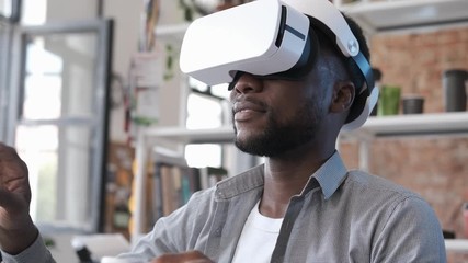 Man wearing VR headset. Using gestures with hands. Handsome man resting use VR glasses. New technologies. Touch something using modern virtual reality glasses. Professional architect or designer - Powered by Adobe