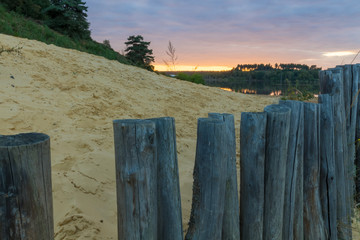 Sunset at the Mechelse Heide (English Mechelse meadow) with a scenic view of being on the beach with sand and wooden poles