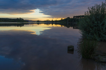 Natural reflections in water of trees at the Mechelse heide (english: Mechelse Meadow) during sunset