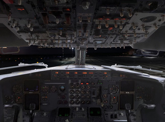 View from airplane pilot cockpit to airfield and airport infrastructure at night