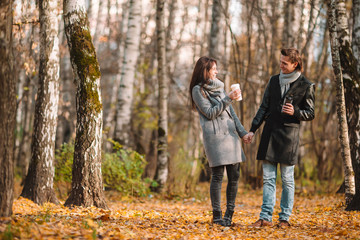 Fototapeta premium Happy family walking in autumn park on sunny fall day