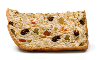 A slice of panettone, an Italian type of sweet bread loaf, with candied fruits and raisins, usually prepared and enjoyed for Christmas and New Year. On a white background ready to be used