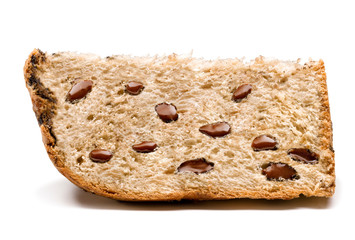 A slice of panettone, an Italian type of sweet bread loaf, with chocolate chips, usually prepared and enjoyed for Christmas and New Year. On a white background ready to be used