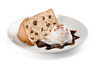 A slice of panettone, an Italian type of sweet bread loaf, with chocolate chips and ice cream...