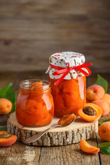 Two jars of homemade apricot jam slices. Close-up