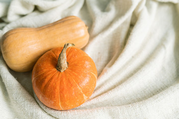 Small group of ripe yellow pumpkins on soft white towel