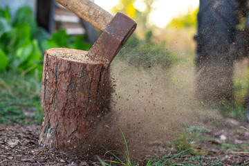 an ax chopping a log and its pieces scatter everywhere