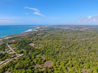 Aerial view of Praia Do Forte coastline town with blue ocean