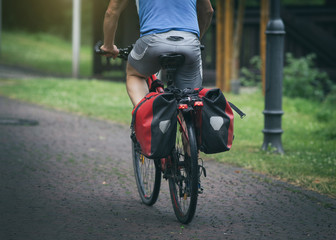 Fototapeta premium Man riding bike with rear seat bags