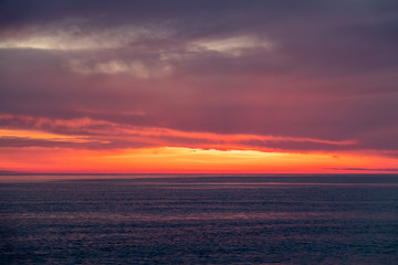 Naklejka na ściany i meble Beautiful red and orange sunset over the sea.