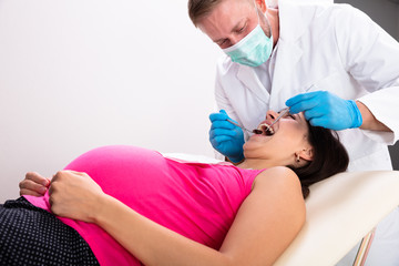 Fototapeta premium Pregnant Woman Having Teeth Examined At Dentists