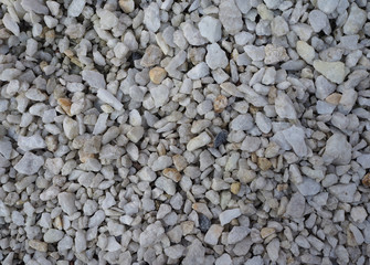 Small white stones for garden decoration close-up gravel background abstract texture top view. .