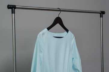 light blue dress hanging on rail
