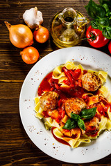 Pasta with meatballs on wooden background