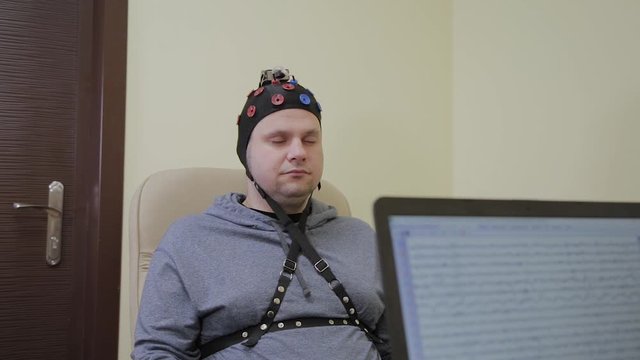 Doctor prepares headset for human brain research.
