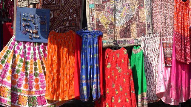 Assortment of colorful clothes for sale in local street market in Udaipur, Rajasthan, India. Close up