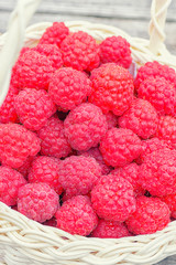 Red raspberries. Healthy and tasty food. Raspberry close-up on the table. Ripe red berry. Raspberries in basket on the table.