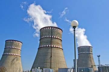 Atomic reactor. Operating nuclear power plant. Smoke from the chimney, blue sky. Power Generation