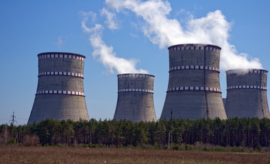 Atomic reactor. Operating nuclear power plant. Smoke from the chimney, blue sky. Power Generation