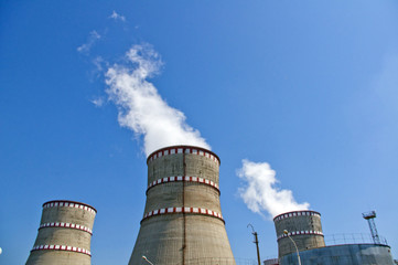 Atomic reactor. Operating nuclear power plant. Smoke from the chimney, blue sky. Power Generation